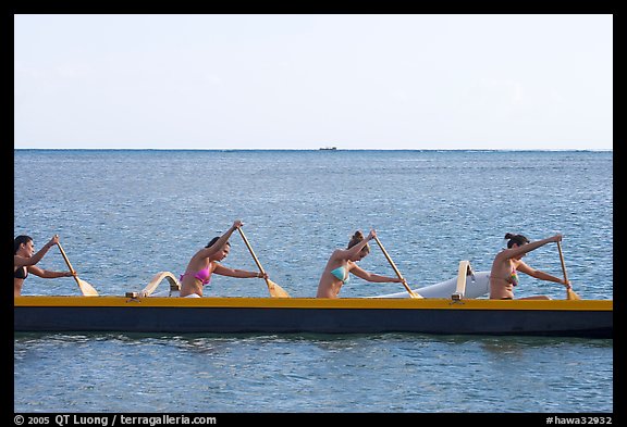 Side view of women in bikini paddling a outrigger canoe, Maunalua Bay, late afternoon. Oahu island, Hawaii, USA (color)