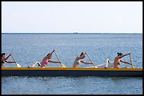 Side view of women in bikini paddling a outrigger canoe, Maunalua Bay, late afternoon. Oahu island, Hawaii, USA ( color)