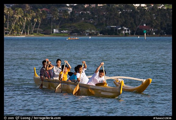 Girls paddling an outrigger canoe, Maunalua Bay, late afternoon. Oahu island, Hawaii, USA