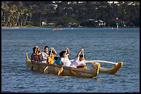 Girls paddling an outrigger canoe, Maunalua Bay, late afternoon. Oahu island, Hawaii, USA (color)