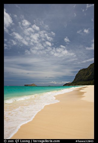 Sand, turquoise waters, and cliff, Waimanalo Beach. Oahu island, Hawaii, USA