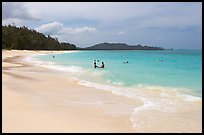 Couple and other bathers in the water, Waimanalo Beach. Oahu island, Hawaii, USA (color)