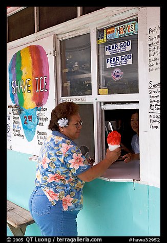 Woman with a flower in hair getting shave ice, Waimanalo. Oahu island, Hawaii, USA (color)