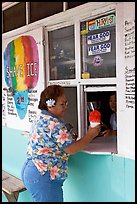 Woman with a flower in hair getting shave ice, Waimanalo. Oahu island, Hawaii, USA