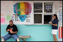 Shave ice store with man sitting eating and woman ordering, Waimanalo. Oahu island, Hawaii, USA