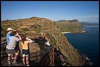 Family on the lookout on the summit of Makapuu head, early morning. Oahu island, Hawaii, USA