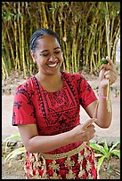 Tonga woman showing how to make cloth out of Mulberry bark. Polynesian Cultural Center, Oahu island, Hawaii, USA ( color)