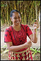 Tonga woman showing how to make cloth out of Mulberry bark. Polynesian Cultural Center, Oahu island, Hawaii, USA