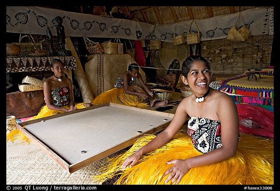 Fiji women sitting at a traditional pool table in vale ni bose (meeting) house. Polynesian Cultural Center, Oahu island, Hawaii, USA (color)
