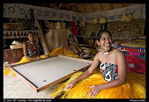 Fiji women sitting at a traditional pool table in vale ni bose (meeting) house. Polynesian Cultural Center, Oahu island, Hawaii, USA