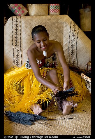 Fiji woman using her feet to tie leaves. Polynesian Cultural Center, Oahu island, Hawaii, USA (color)