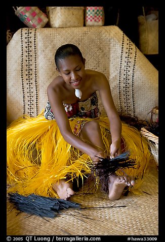 Fiji woman using her feet to tie leaves. Polynesian Cultural Center, Oahu island, Hawaii, USA