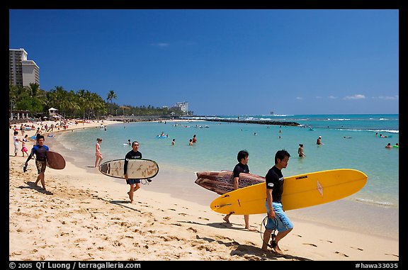 Men walking on Waikiki Beach with surfboards. Waikiki, Honolulu, Oahu island, Hawaii, USA (color)