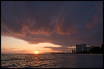 Sun setting and Honolulu skyline. Waikiki, Honolulu, Oahu island, Hawaii, USA