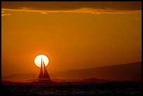 Sailboat and sun disk, sunset. Waikiki, Honolulu, Oahu island, Hawaii, USA ( color)