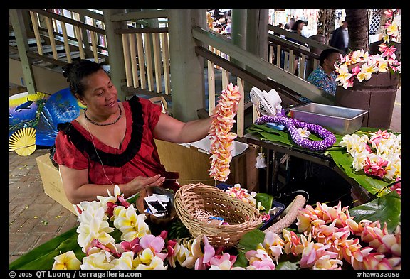 Woman showing  a fresh flower lei, International Marketplace. Waikiki, Honolulu, Oahu island, Hawaii, USA (color)