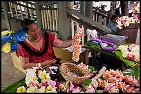 Woman showing  a fresh flower lei, International Marketplace. Waikiki, Honolulu, Oahu island, Hawaii, USA (color)