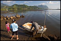 Fisherman with family and small baot, Kaneohe Bay, morning. Oahu island, Hawaii, USA ( color)