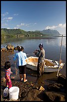 Fishing family working around small baot, Kaneohe Bay, morning. Oahu island, Hawaii, USA