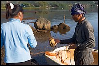 Fisherman giving a freshly caught crab to his wife, Kaneohe Bay, morning. Oahu island, Hawaii, USA