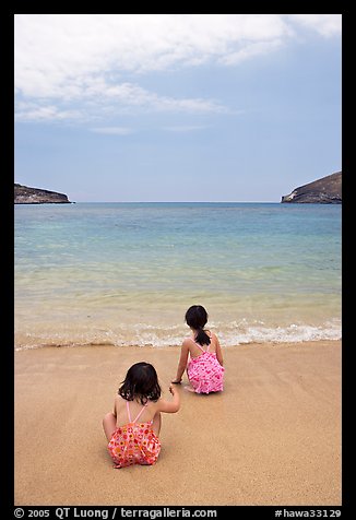 Two girls at the edge of water, Hanauma Bay. Oahu island, Hawaii, USA (color)