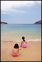 Two girls at the edge of water, Hanauma Bay. Oahu island, Hawaii, USA