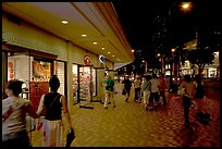 Shops on Kalakaua avenue at night. Waikiki, Honolulu, Oahu island, Hawaii, USA (color)