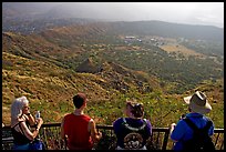 Tourists look at the  Diamond Head crater, early morning. Oahu island, Hawaii, USA