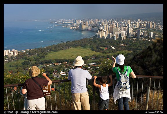 Tourists look at Waikidi from the  Diamond Head crater, early morning. Oahu island, Hawaii, USA (color)