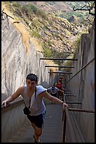 Tourist climbing a staircase on the Diamond Head summit trail. Oahu island, Hawaii, USA