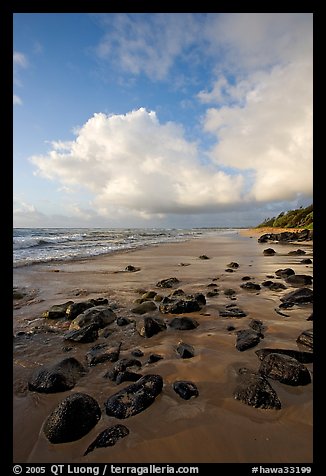 Boulders, coastline, and clouds, Lydgate Park, sunrise. Kauai island, Hawaii, USA