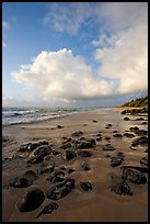 Boulders, coastline, and clouds, Lydgate Park, sunrise. Kauai island, Hawaii, USA