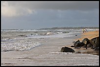 Couple strolling on the beach, Lydgate Park, early morning. Kauai island, Hawaii, USA ( color)