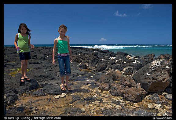 Girls playing in tidepool, Kukuila. Kauai island, Hawaii, USA (color)