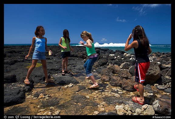 Girls playing in tidepool, Kukuila. Kauai island, Hawaii, USA