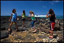 Girls playing in tidepool, Kukuila. Kauai island, Hawaii, USA (color)