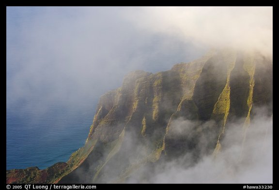 Fluted ridges seen through clouds, Kalalau lookout, late afternoon. Kauai island, Hawaii, USA