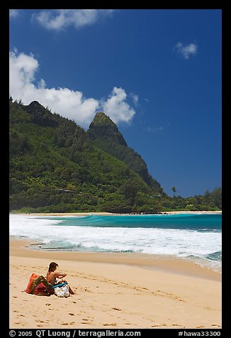 Woman sitting on a beach chair on Tunnels Beach. North shore, Kauai island, Hawaii, USA