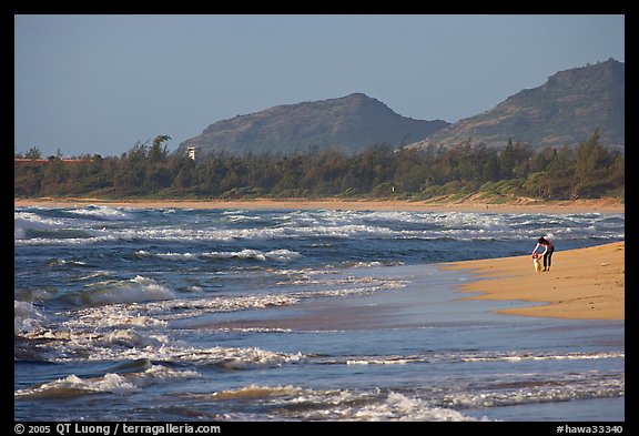 Woman with child on beach, Lydgate Park, early morning. Kauai island, Hawaii, USA (color)