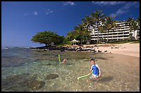 Children on Puu Poa Beach and Princeville Hotel. Kauai island, Hawaii, USA ( color)