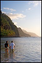 Couple looking at the Na Pali Coast, Kee Beach, late afternoon. Kauai island, Hawaii, USA