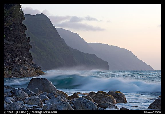 Boulders, waves, and Na Pali Coast, sunset. North shore, Kauai island, Hawaii, USA (color)