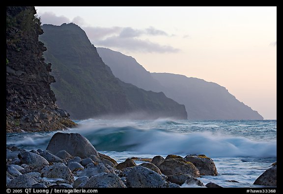 Boulders, waves, and Na Pali Coast, sunset. North shore, Kauai island, Hawaii, USA