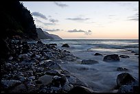 Boulders, waves, and Na Pali Coast, sunset. North shore, Kauai island, Hawaii, USA (color)