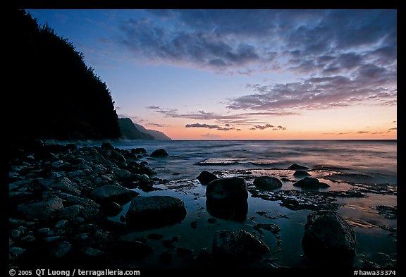 Boulders, surf, and Na Pali Coast, dusk. Kauai island, Hawaii, USA (color)