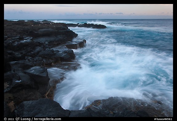 Surf and lava shoreline at sunset, South Point. Big Island, Hawaii, USA