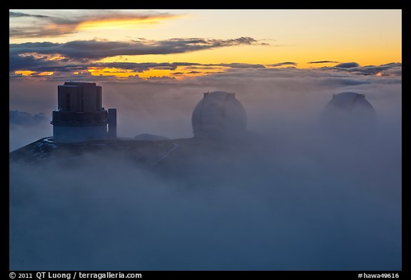 Telescopes, clouds, and fog at sunset. Mauna Kea, Big Island, Hawaii, USA