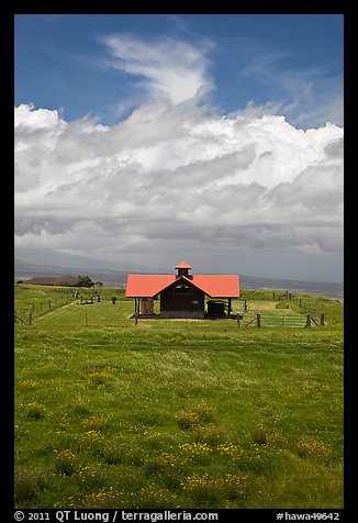 Rural building with bright red roof in ranchland. Big Island, Hawaii, USA