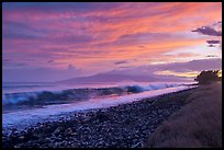 Crashing wave, Lanai Island, and colorful sunset clouds. Lahaina, Maui, Hawaii, USA