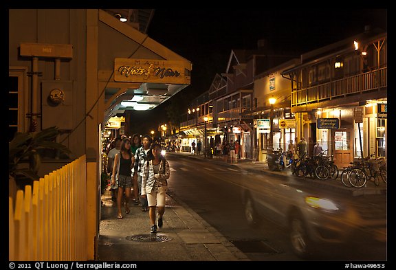 Tourists strolling store-lined street at night. Lahaina, Maui, Hawaii, USA